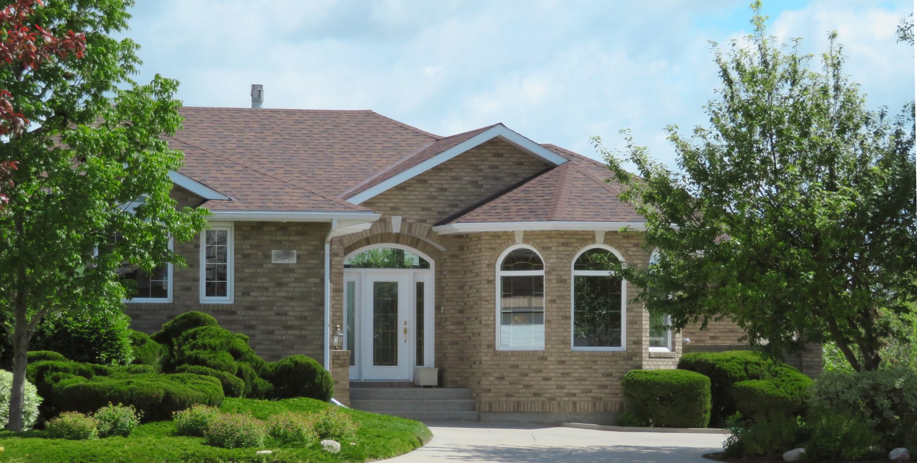 Brick single-story home with mature landscaping